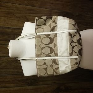 Small tan coach bucket bag